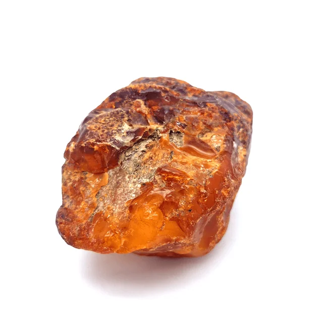 Ámbar natural como símbolo visual; la nota perfumística es un acorde, no la piedra.